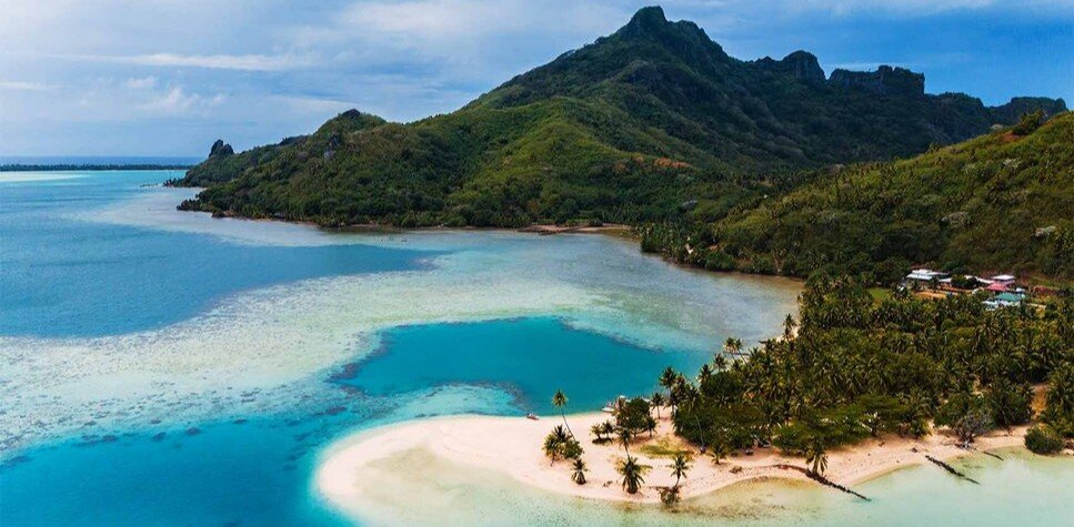 Tereia Beach in Maupiti with turquoise lagoon and green mountain in French Polynesia