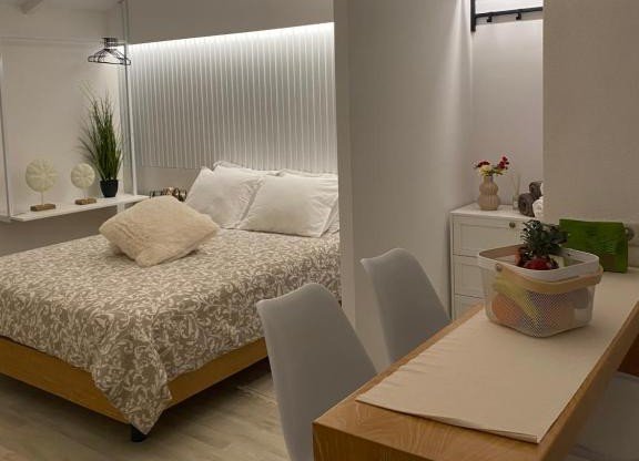 modern bedroom at Seaside 12 with soft tones, natural light, and comfortable bed near the beach