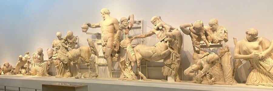 ancient Greek statues displayed in a museum at Olympia showing classical sculptures and figures