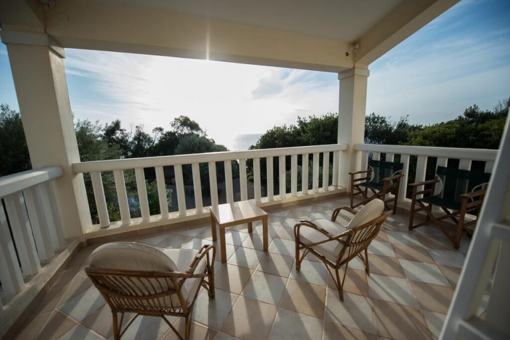 covered terrace with seating and ocean view at Villa Feia Beach Hotel in Katakolon Greece