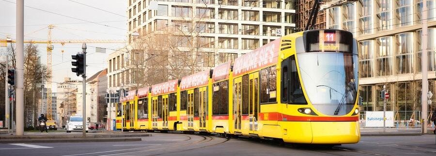 Yellow Basel tram traveling through the city in Switzerland
