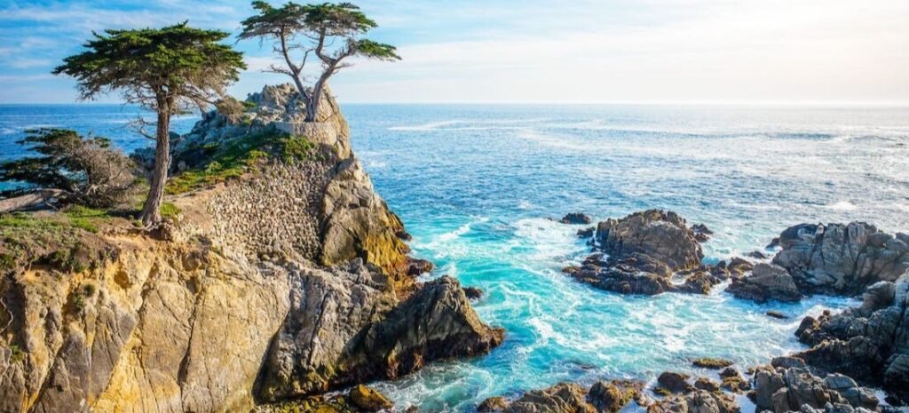 Iconic rocky coastline with Monterey cypress trees overlooking the Pacific Ocean in Monterey, California.