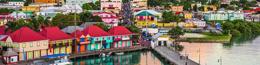 Antigua and Barbuda colorful harbor waterfront with bright Caribbean buildings and coastal town views
