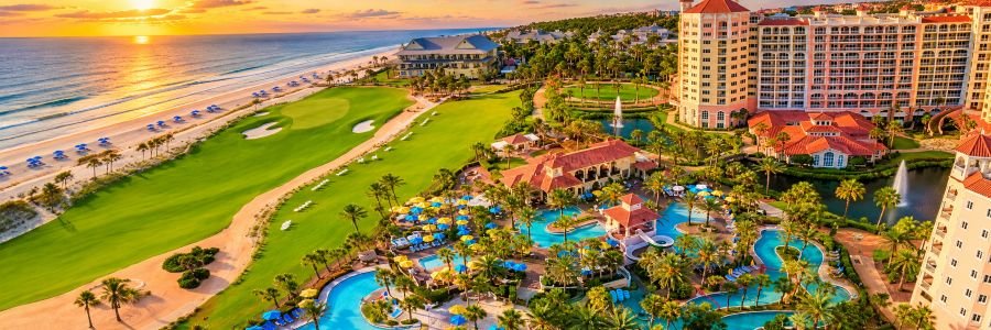 Hammock Beach Golf Resort & Spa in Florida featuring oceanfront golf, tropical pools, palm trees and beachfront resort accommodations.