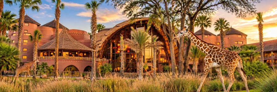 Disney’s Animal Kingdom Lodge in Orlando with giraffes roaming the savanna in front of the African-inspired resort.