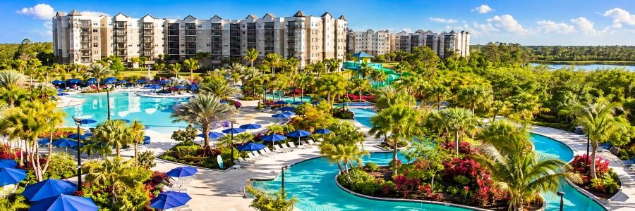 The Grove Resort & Water Park Orlando featuring tropical landscaping, resort pools, a lazy river and surrounding resort buildings.