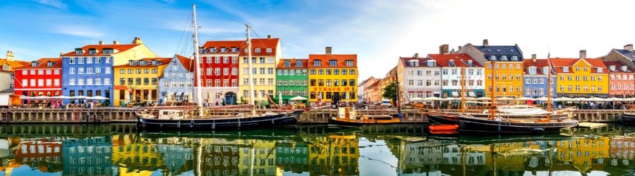 Colorful canal houses and boats along Nyhavn in Copenhagen, Denmark.
