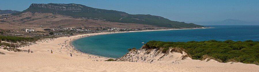 Playa de Bolonia Cadiz Spain wide beach with sand dunes and blue water
