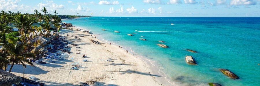 10 Most Beautiful Beaches | Bávaro Beach, Punta Cana Bávaro Beach in Punta Cana with white sand, turquoise Caribbean water, palm trees, loungers, and beachfront resorts.