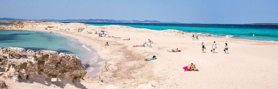 Ses Illetes beach in Formentera with turquoise Mediterranean water white sand and coastal views