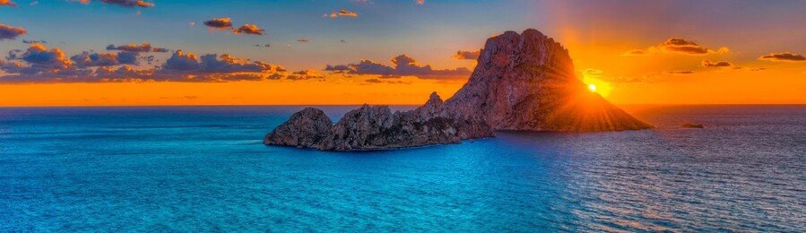 Es Vedra sunset in Ibiza with Mediterranean sea rocky island silhouette and colorful sky Balearic Islands Spain