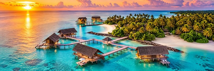One&Only Reethi Rah in the Maldives with overwater villas, turquoise lagoon, white sand beach, and a tropical sunset.