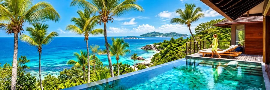 Six Senses Zil Pasyon in the Seychelles with a private infinity pool, tropical palms, and brilliant blue ocean views.