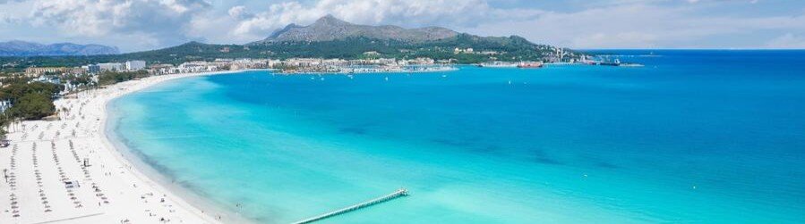 Playa de Alcudia Mallorca Spain coastline with turquoise water and long sandy beach
