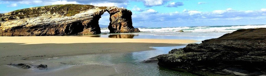 Playa de las Catedrales Galicia Spain rock arches and sandy beach at low tide