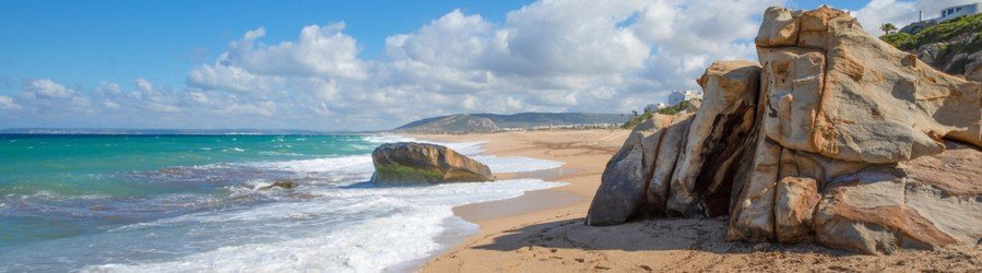 Playa de Zahara de los Atunes Cadiz Spain beach with rock formations and clear water