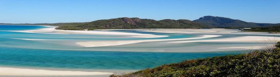 Aerial view of turquoise waters and white sand at Airlie Beach and the Whitsundays in Queensland.