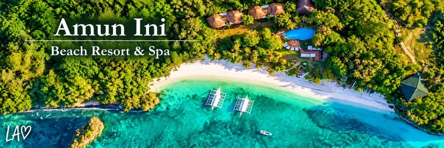 Aerial view of Amun Ini Beach Resort & Spa in Anda, Bohol, featuring a secluded white-sand beach, turquoise waters, lush tropical greenery, and beachfront villas.