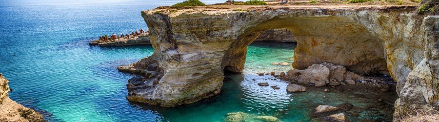 Natural rock arch and clear turquoise water at Baia dei Turchi near Otranto in Puglia