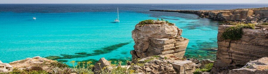 Cala Rossa in Favignana with turquoise water and rocky limestone cliffs