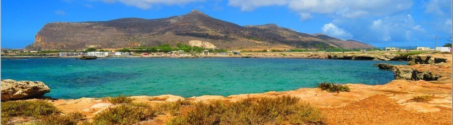 Lido Burrone beach in Favignana with clear water and rocky shoreline