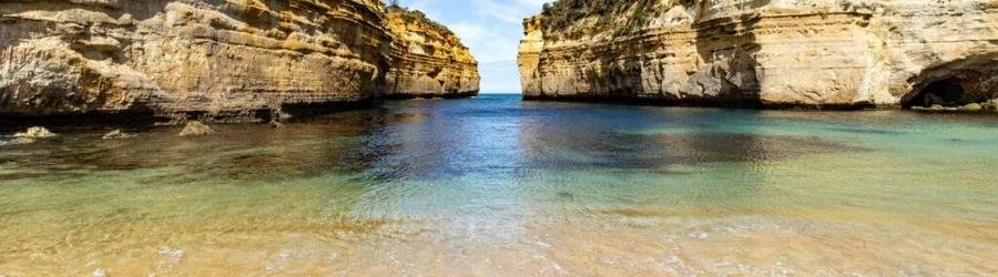Loch Ard Gorge beach in Victoria, Australia with golden cliffs and turquoise waters.