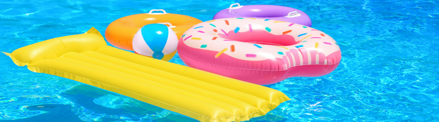 Colorful pool inflatables including a yellow lounger, beach ball, and donut float in bright blue water.