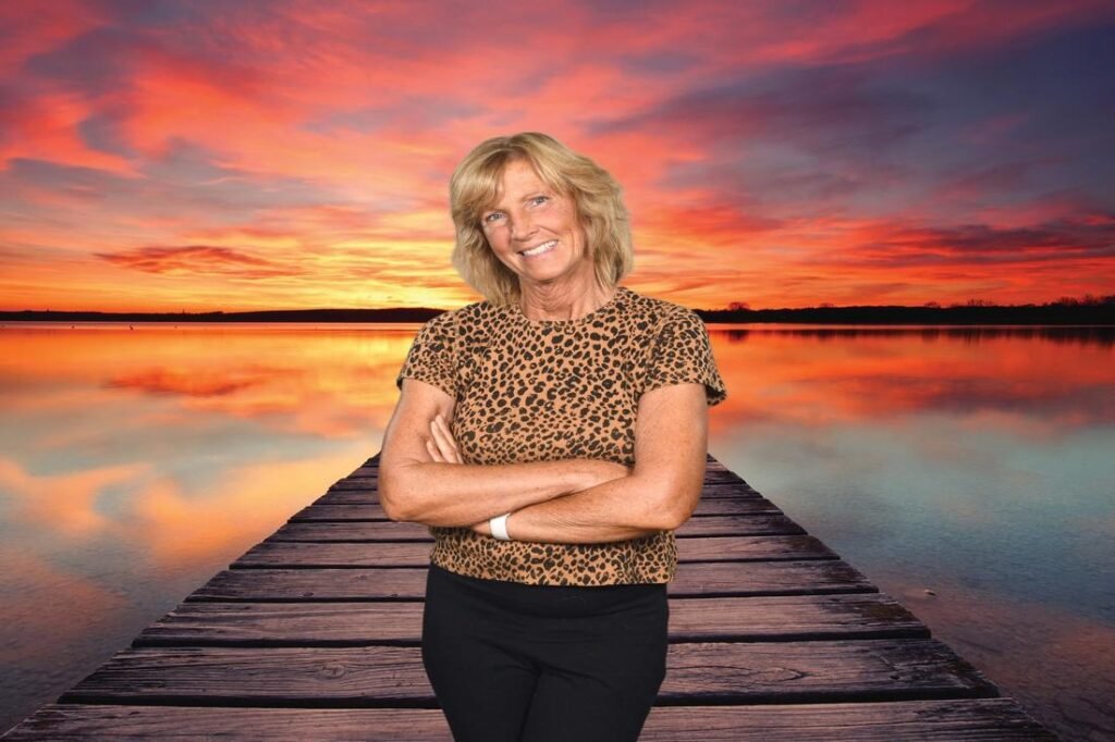 Leahrae, a beach travel expert, standing on a pier at sunset and sharing her passion for beach travel destinations.