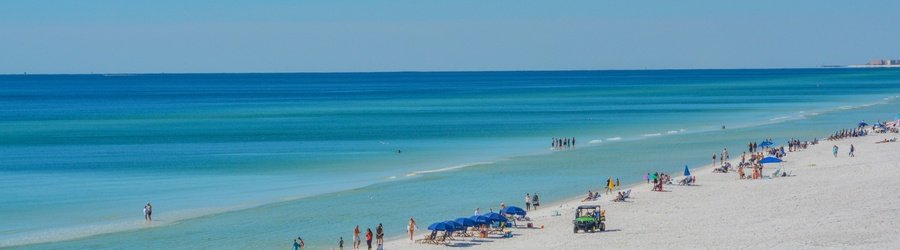 grayton beach florida shoreline with turquoise water and people along the white sand