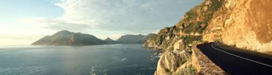 Scenic drive along the rugged cliffs of the Cape Peninsula South Africa overlooking the deep blue Atlantic Ocean.