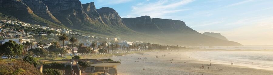 Golden beaches and rugged peaks of Cape Town South Africa at sunset.