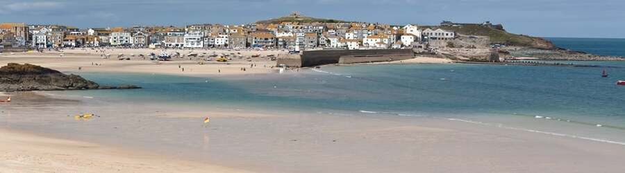 The sandy beach and charming harbor town of St Ives on the north coast of Cornwall UK.