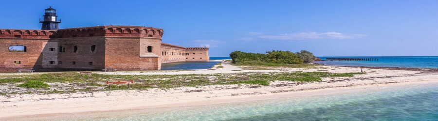 Fort Jefferson and the sandy shoreline of Dry Tortugas National Park surrounded by turquoise water.