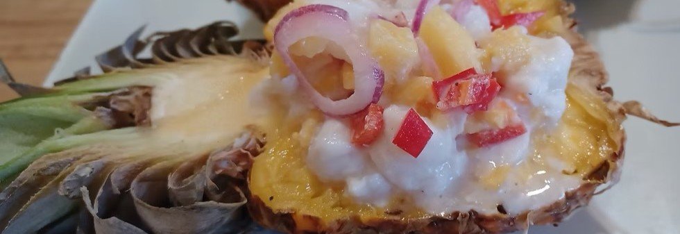 Ika mata traditional Cook Islands raw fish dish served in a pineapple bowl with coconut cream