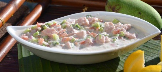 Ika Mata dish in a white serving bowl with fresh coconut cream, lime, and island vegetables in the Cook Islands.