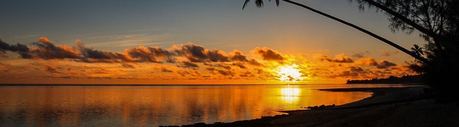 Fiery golden sunset over the water in Rarotonga, Cook Islands