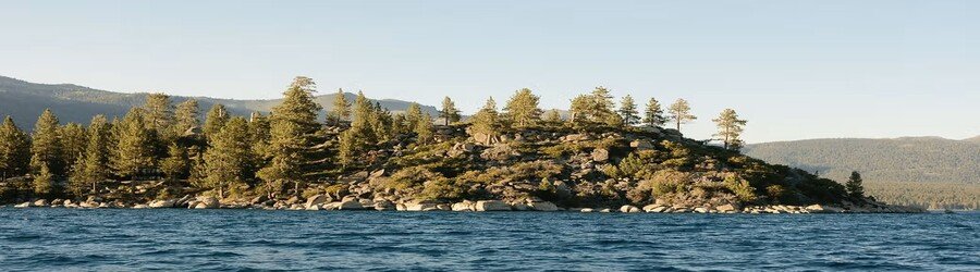 lake tahoe forested shoreline near sand harbor with calm blue water