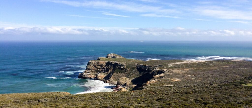 Cape Peninsula South Africa coastline with rugged cliffs at Cape Point overlooking the deep blue Atlantic Ocean.
