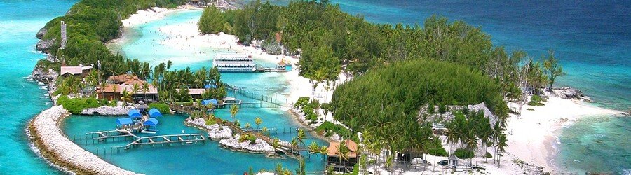 Blue Lagoon Island Nassau with white sand beaches, clear water, and lush trees