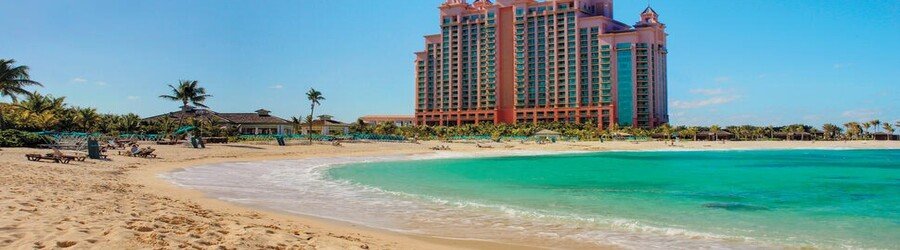 Calm turquoise water and soft sand stretching below The Cove at Atlantis on Paradise Island.