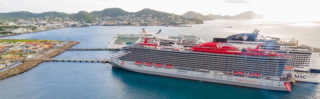 Cruise ships docked at Port Zante in Basseterre, St. Kitts with the town and green hills in the background.
