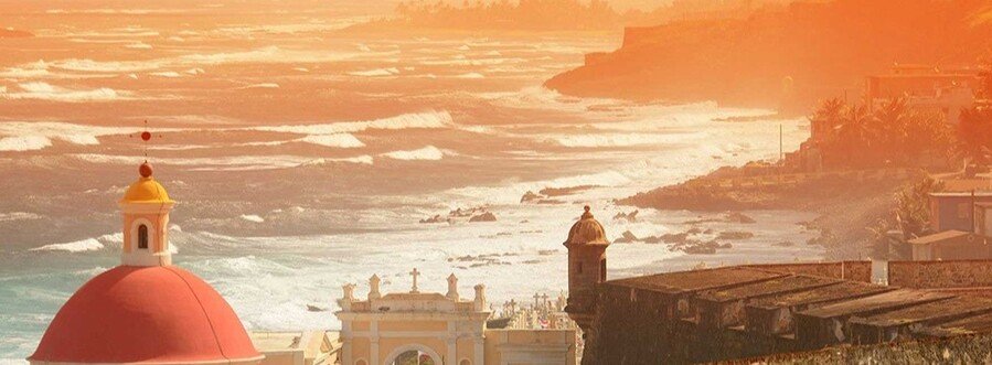 Sunset over Old San Juan coastline with historic fort and ocean waves