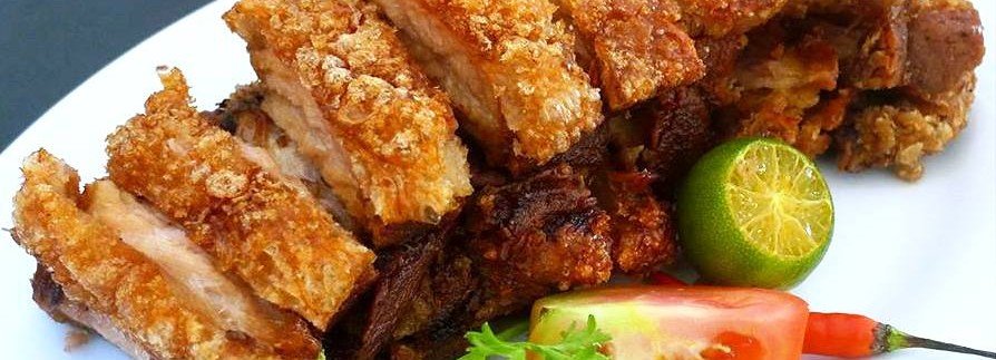 Bagnet ng Ilocos crispy Ilocano pork served with calamansi and vegetables