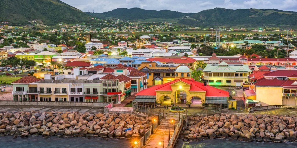Aerial view of Basseterre St. Kitts cruise port with colorful buildings and mountains in the background.