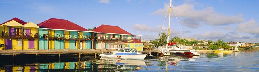 Colorful waterfront houses and boats in St. John’s Antigua