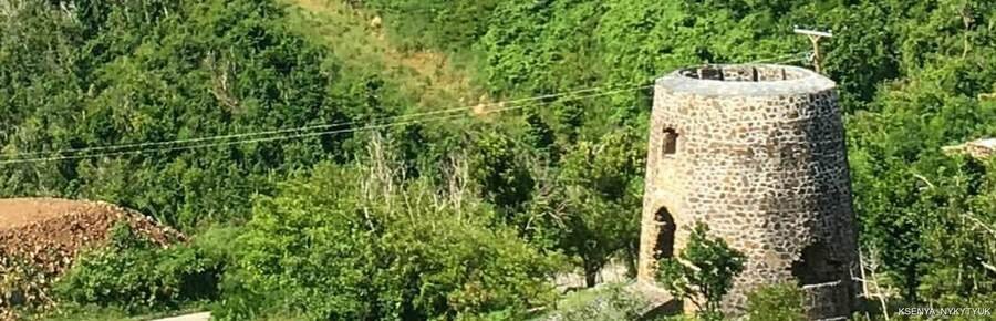 Historic Mount Healthy stone windmill surrounded by green hills
