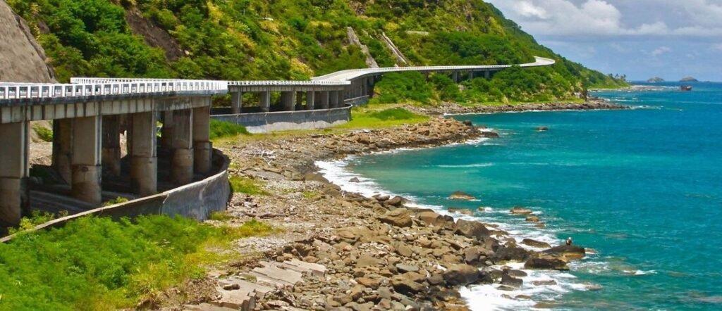 Patapat Viaduct in Pagudpud Philippines overlooking rugged coastline and bright blue ocean