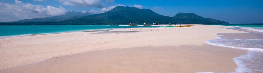White Island sandbar in Camiguin with clear water and Mount Hibok-Hibok in the background