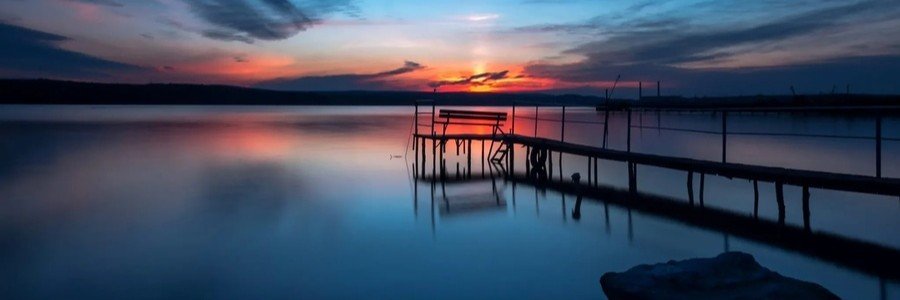 Göhren pier at blue hour on Rügen Island with dramatic Baltic Sea sunset and reflections.