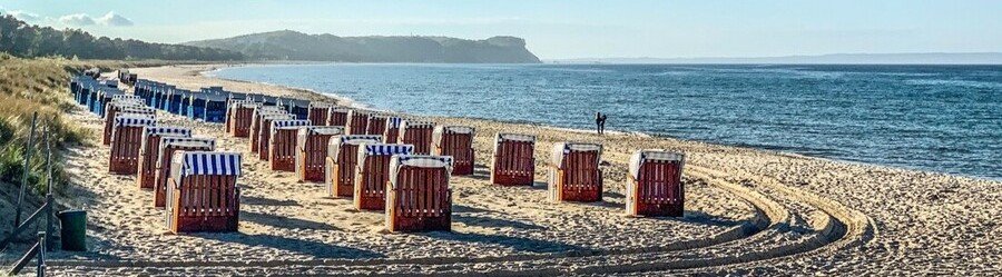 Strandkorb beach chairs on Göhren Beach Rügen Germany along the Baltic Sea coastline.